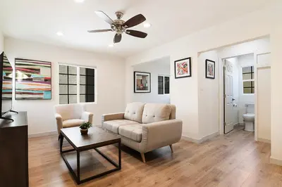 a living room with a couch and a ceiling fan at Freshly Renovated Studio for Two in the Heart of LA in Los Angeles