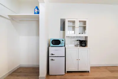 a kitchen with a white cabinet and a microwave at Freshly Renovated Studio for Two in the Heart of LA in Los Angeles