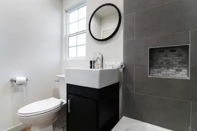 a bathroom with a toilet and a sink and a mirror at Freshly Renovated Studio for Two in the Heart of LA in Los Angeles