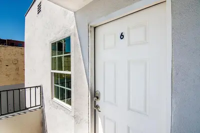 an open white door of a building with a window at Upper-Level Studio Suite Close to Beverly Hills in Los Angeles