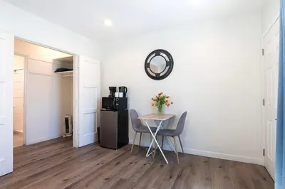 a dining room with a table and a refrigerator at Upper-Level Studio Suite Close to Beverly Hills in Los Angeles