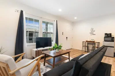 a living room with a couch and a tv at Cozy Studio Suite Near Beverly Hills for Two in Los Angeles