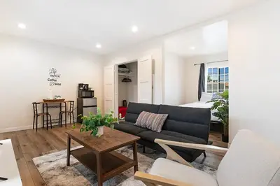 a living room with a couch and a table at Cozy Studio Suite Near Beverly Hills for Two in Los Angeles