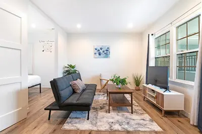 a living room with a chair and a television at Cozy Studio Suite Near Beverly Hills for Two in Los Angeles