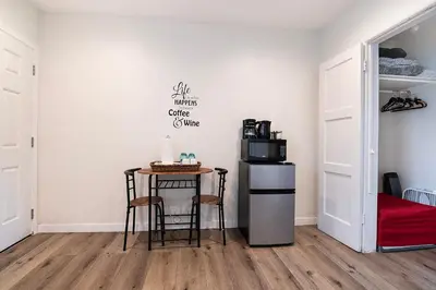 a room with a table and a microwave and a refrigerator at Cozy Studio Suite Near Beverly Hills for Two in Los Angeles