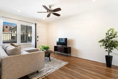 a living room with a couch and a ceiling fan at Affordable One-Bedroom Close to Pico and Beverly Hills in Los Angeles