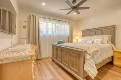 a bedroom with a large bed and a ceiling fan at Southbaysunshine coastal Villa by beach-30 plus Days in Torrance
