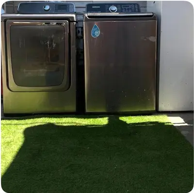 a green dishwasher sitting in the grass with its shadow at Hidden Gem in San Bernardino