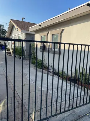 a black fence in front of a house at Hidden Gem in San Bernardino