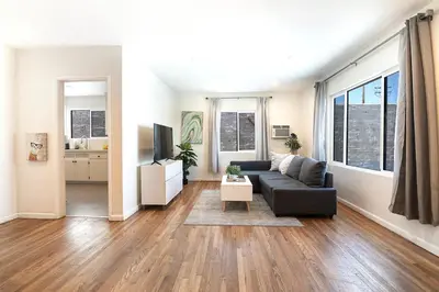 a living room with a couch and a tv at Comfortable One-Bedroom with Two Queen Beds in Los Angeles