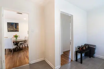 a hallway with a door to a dining room with a table at Comfortable One-Bedroom with Two Queen Beds in Los Angeles