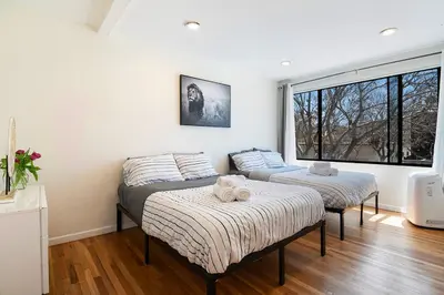 two beds in a room with a window at Comfortable One-Bedroom with Two Queen Beds in Los Angeles