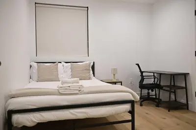 a bedroom with a bed with a chair and a desk at Calm Luxe Ensuite Room near USC-Shared Home in Los Angeles