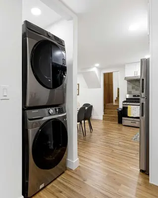 a microwave sitting on top of a dryer in a living room at Family Retreat Near Disneyland & Downtown LA 4BR in Los Angeles