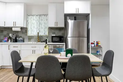 a kitchen with a table with chairs and a refrigerator at Family Retreat Near Disneyland & Downtown LA 4BR in Los Angeles