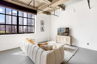 a white living room with a couch and a tv at DTLA Boutique Loft w Rooftop Pool Hot Tub in Los Angeles