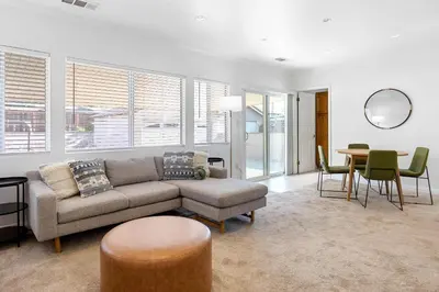 a living room with a couch and a table at Family Oasis Near Disneyland & Knotts in Downey