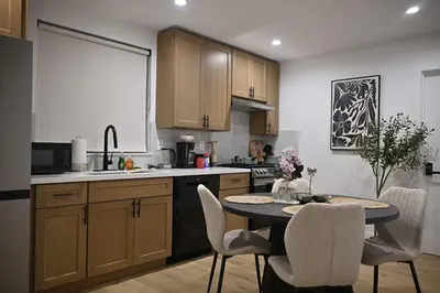 a kitchen with a table and chairs in a kitchen at Luxe Ensuite in Shared Home-Minutes to USC in Los Angeles