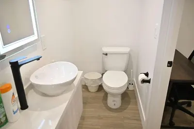 a bathroom with a white toilet and a sink at Luxe Ensuite in Shared Home-Minutes to USC in Los Angeles