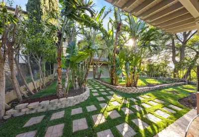 a garden with palm trees and a walkway at Tranquil Hideaway Private Retreat with Mountain Views in Tujunga