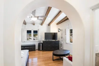 an archway leads into a living room with a tv at Cozy Beverly Hills Studio Near Shopping with Kitchen in Los Angeles