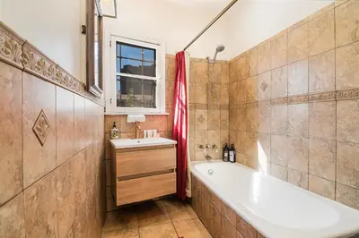 a bathroom with a tub and a sink at Cozy Beverly Hills Studio Near Shopping with Kitchen in Los Angeles
