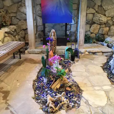 a flower garden in a stone room with a bench at Family Nature Retreat Near LA with Indoor Grotto Pool in Simi Valley