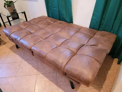 a brown leather couch sitting in a room at 2BR Guest Suite With Parking and Garden in Pico Robertson Near Beverly Hills and Cedar Sinai in Los Angeles