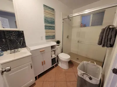 a bathroom with a toilet and a glass shower at 2BR Guest Suite With Parking and Garden in Pico Robertson Near Beverly Hills and Cedar Sinai in Los Angeles