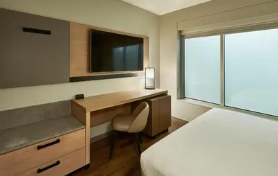 a bedroom with a desk and a bed and a television at Hyatt Place Ontario Airport in Ontario