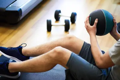 two men sitting on the floor with weights at Hyatt House Ontario Airport in Ontario