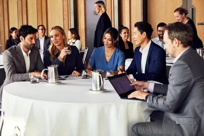 a group of people sitting around a table with a laptop at Hyatt House Ontario Airport in Ontario