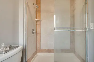 a shower with a glass door in a bathroom at Melrose Hill Home Near Hospitals Nurses Welcome! in Los Angeles