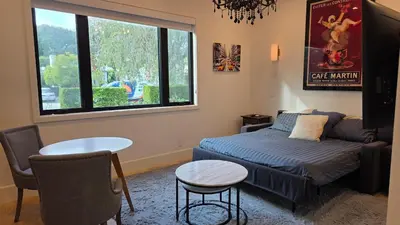 a bedroom with a bed and a couch and a table at Modern Studio with Kitchen Parking Near Beverly Hills and Culver City in Los Angeles