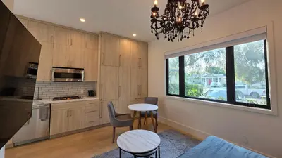 a kitchen with a table and chairs and a window at Modern Studio with Kitchen Parking Near Beverly Hills and Culver City in Los Angeles