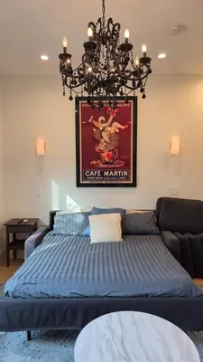 a bedroom with a bed and a chandelier at Modern Studio with Kitchen Parking Near Beverly Hills and Culver City in Los Angeles