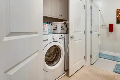a white laundry room with a washer and dryer at 12 Mi to DTLA! Multi-Level Charmer with Pool Access in Montebello