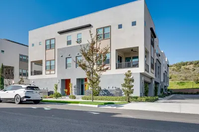 a white car parked in front of a building at 12 Mi to DTLA! Multi-Level Charmer with Pool Access in Montebello