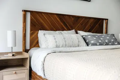 a bedroom with a large bed with a wooden headboard at Spacious 2bedroom in Hollywood with Parking Gym Pool in Los Angeles