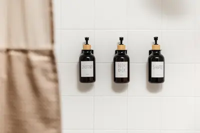 a row of black bottles on a white tiled wall at Spacious 2bedroom in Hollywood with Parking Gym Pool in Los Angeles