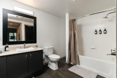 a bathroom with a sink and a toilet and a tub at Spacious 2bedroom in Hollywood with Parking Gym Pool in Los Angeles