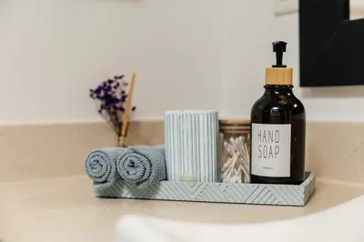 a bottle of hand soap and towels on a bathroom sink at Spacious 2bedroom in Hollywood with Parking Gym Pool in Los Angeles