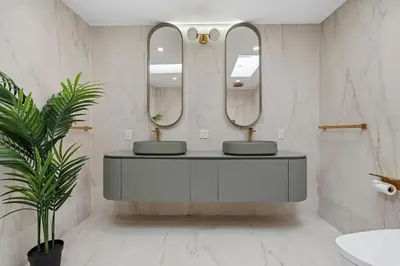 a bathroom with two sinks and two mirrors at The Sinatra House- Fully Furnished! in Los Angeles