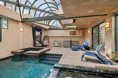 a swimming pool in a house with a glass ceiling at The Sinatra House- Fully Furnished! in Los Angeles
