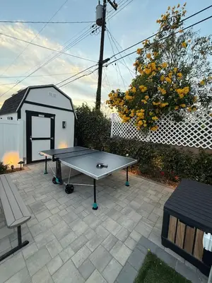 a ping pong table on a patio with a shed at Private 3BR Home - Hot Tub, Yard, Arcade & Parking in Simi Valley