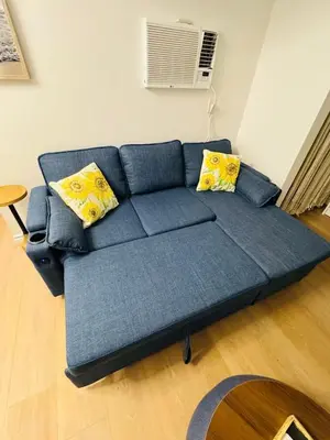 a blue couch with yellow pillows in a living room at Cozy Villa with Spa, Fireplace, Kitchen, Yard, BBQ in Simi Valley