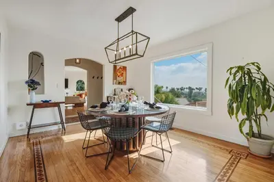 a dining room with a table and chairs and a window at New Listing Elevated Hillside Living by Colby & Conrad in Los Angeles