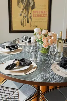 a table with plates and flowers and wine glasses at New Listing Elevated Hillside Living by Colby & Conrad in Los Angeles
