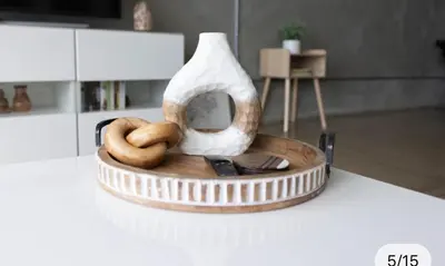a wooden tray with a vase and two bagels on a table at Chic urban loft steps from dining and shopping in Los Angeles