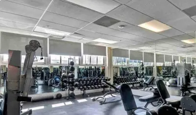 a gym with lots of chairs and machines at Chic urban loft steps from dining and shopping in Los Angeles